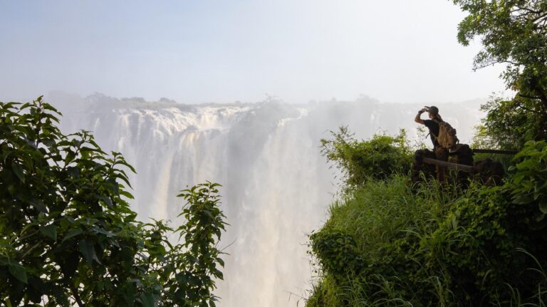 Woman looking out at Victoria Falls